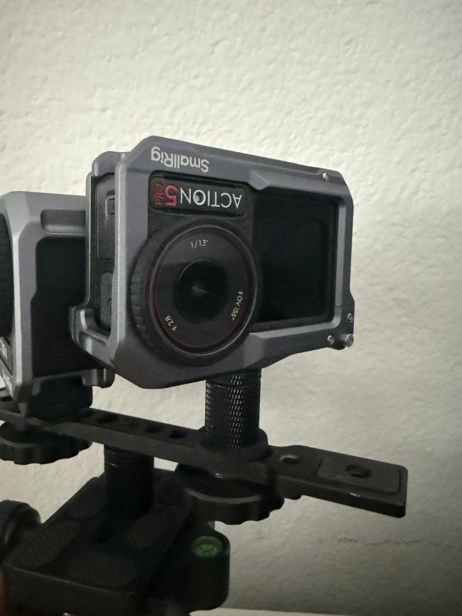 Close-up of the second camera riding upside down in its cage, its lens almost touching the first camera